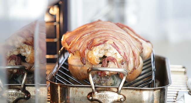 a cooked turkey with crisp bacon