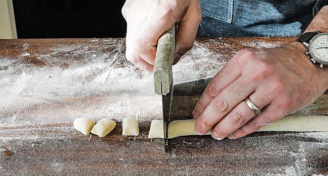 cutting dough into gnocchi
