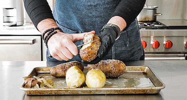 peeling baked potatoes