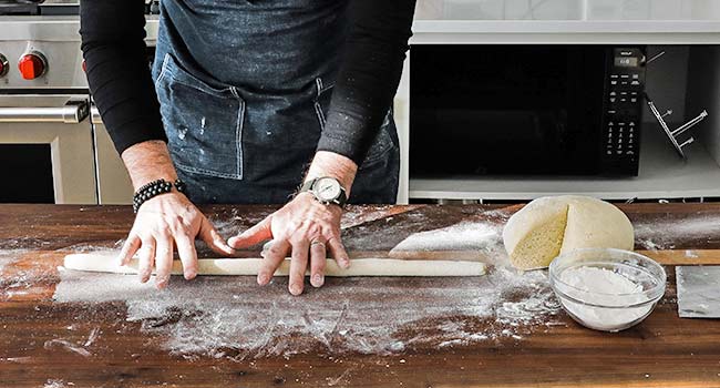 rolling out gnocchi dough