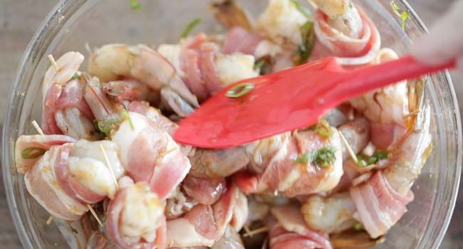 coating bacon-wrapped shrimp in soy sauce