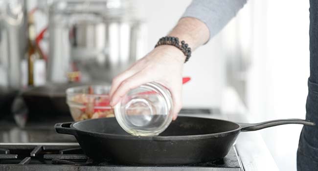 adding oil to a pan