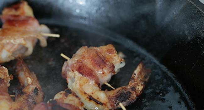 searing bacon-wrapped shrimp