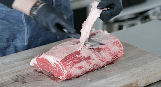 trimming a roast beef