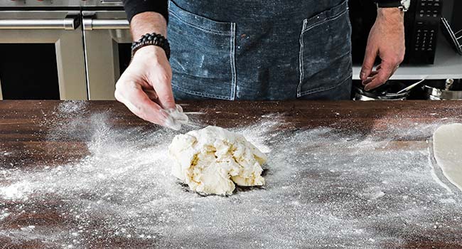 sprinkling butter with flour