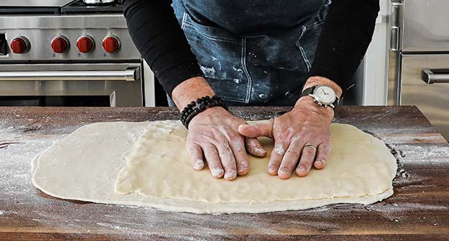 placing butter onto rolled out dough