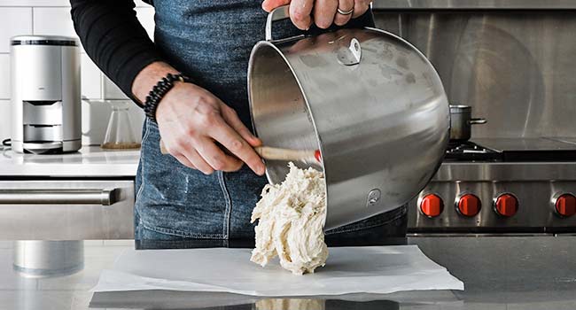 adding dough to a parchment sheet