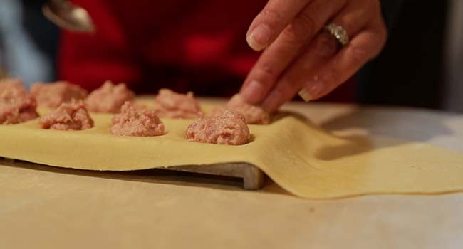 adding meat to pasta