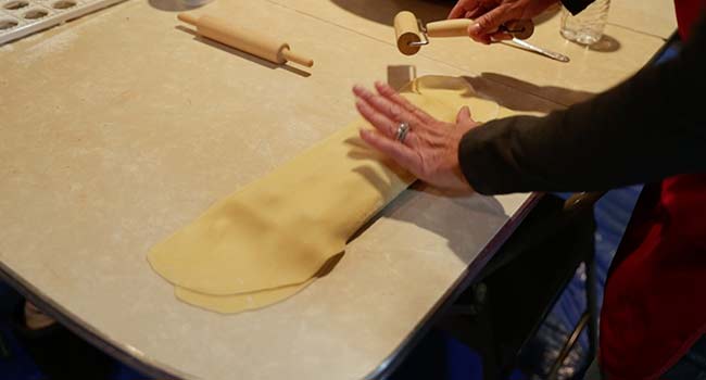 adding a pasta sheet over ravioli