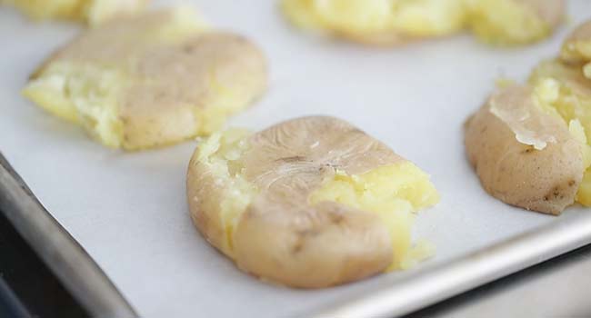 smashed potatoes on a sheet tray