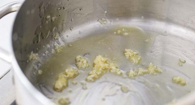 sautéing garlic in a pan