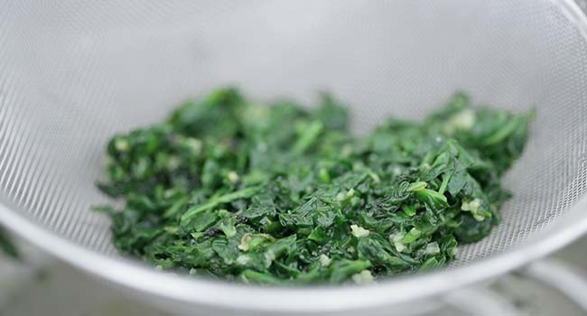 draining spinach