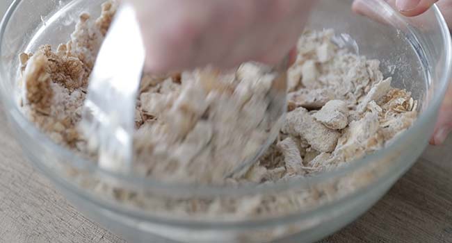 cutting butter into flour and oats