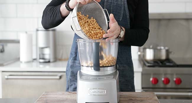 adding beans to a food processor