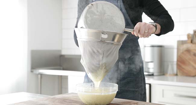 straining a vanilla bean custard