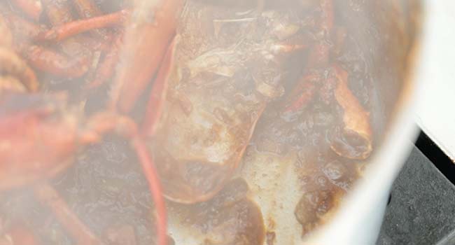 cooking down port wine in a pot of lobsters