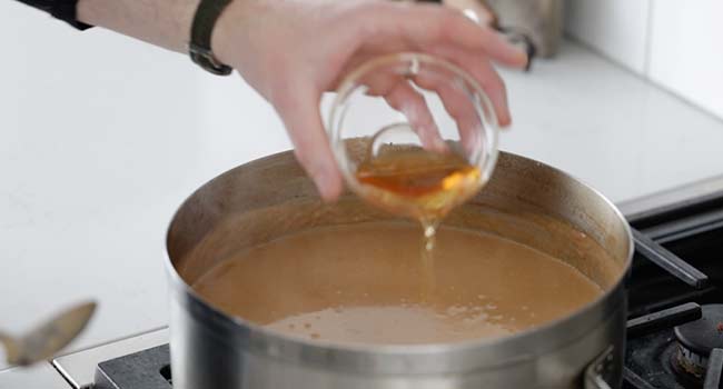 adding brandy to lobster bisque