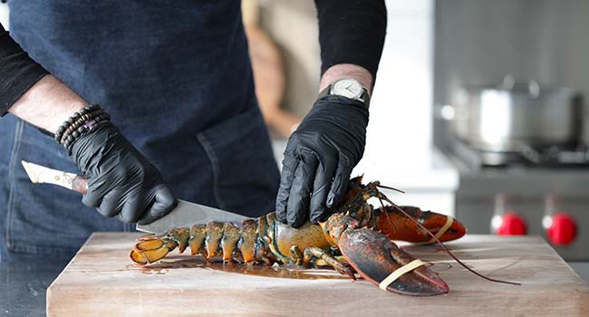 slicing through a lobster tail