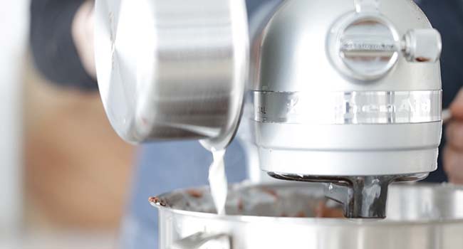 pouring hot milk to a mixer