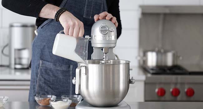 adding whipped cream to a stand mixer