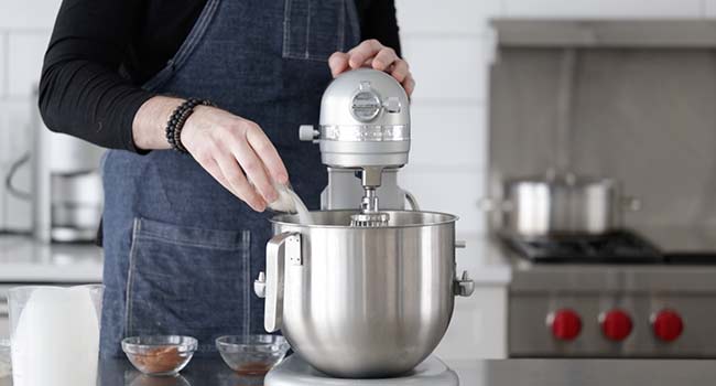 pouring sugar to a stand mixer