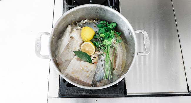 parsley and lemons in a pot with fish bones