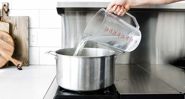 pouring water into a pot