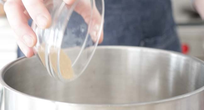 adding yeast to a bowl