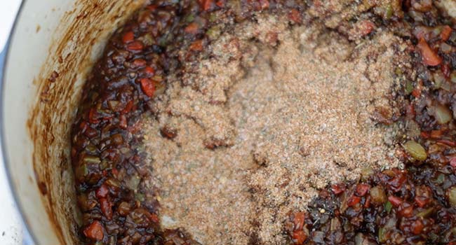 adding seasoning to cooked vegetables