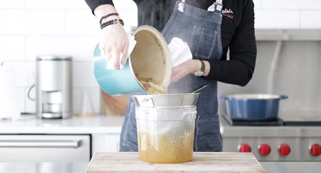 straining a chicken stock