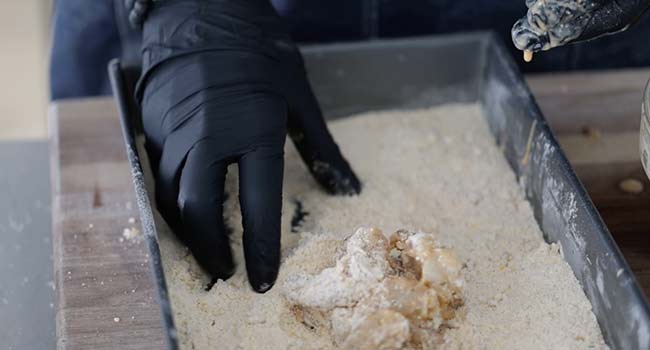 adding shrimp to a flour batter