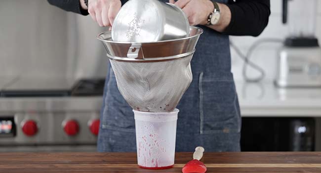 straining a raspberry coulis