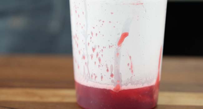 raspberry coulis in a container