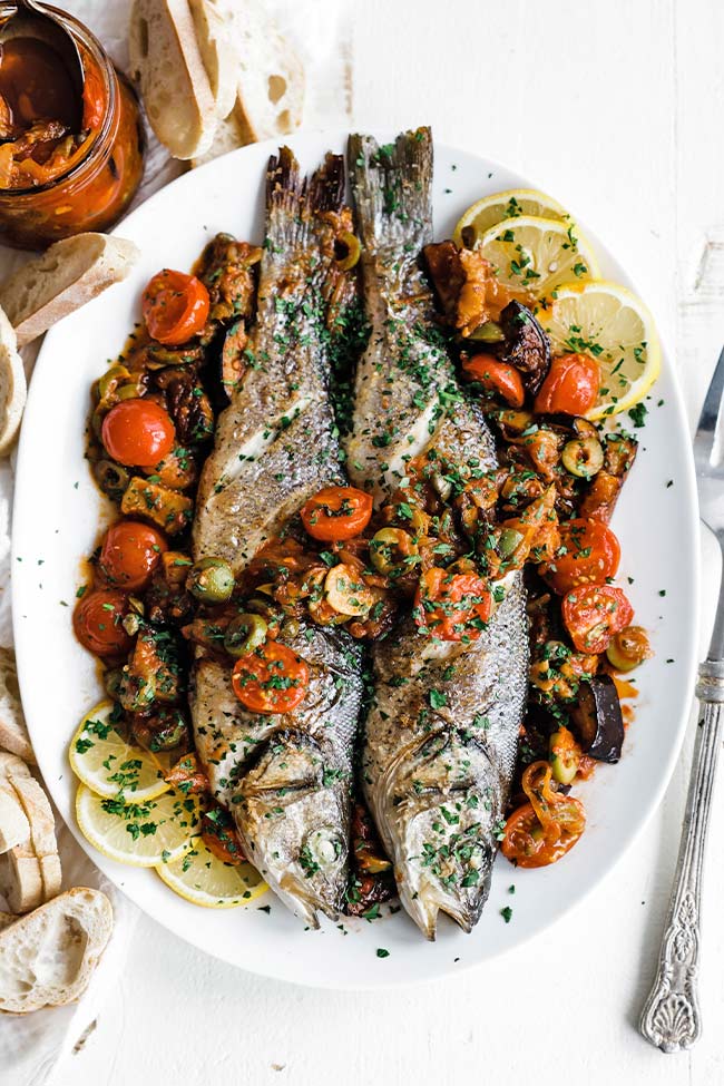 whole branizno on a platter with caponata