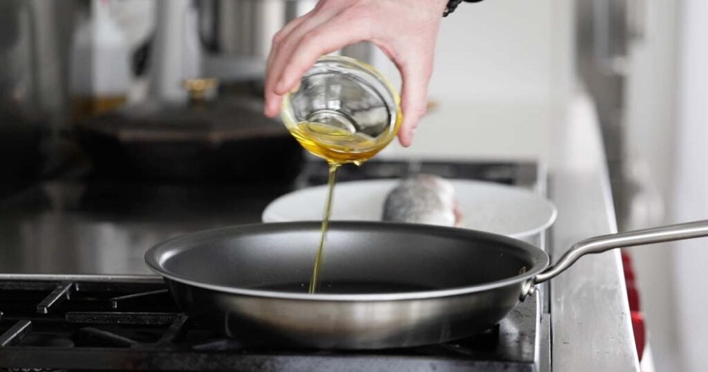 adding oil to a non-stick skillet