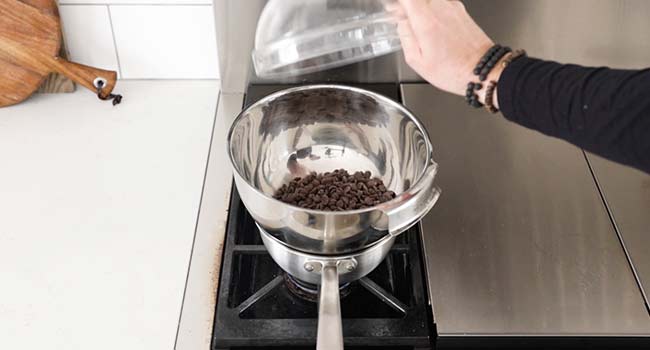 adding chocolate to a double boiler