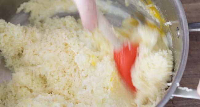 mixing potatoes with eggs and milk