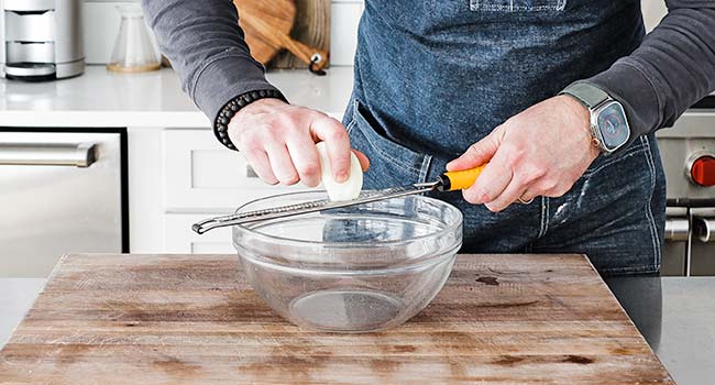 finely grating an onion