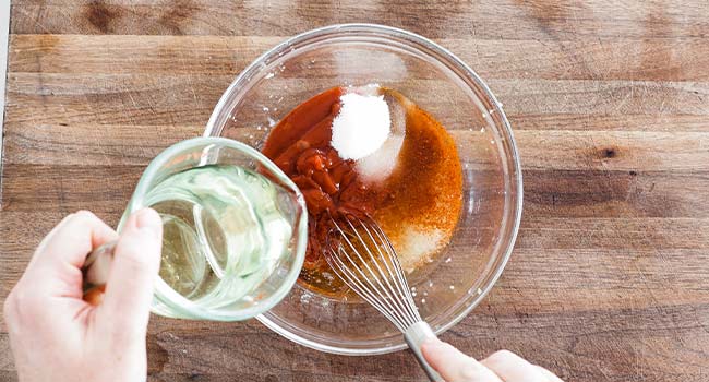 whisking oil into a dressing