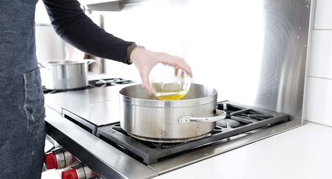 adding oil to a pan