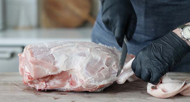 removing skin from a ham