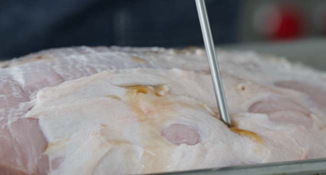 injecting a ham with brine