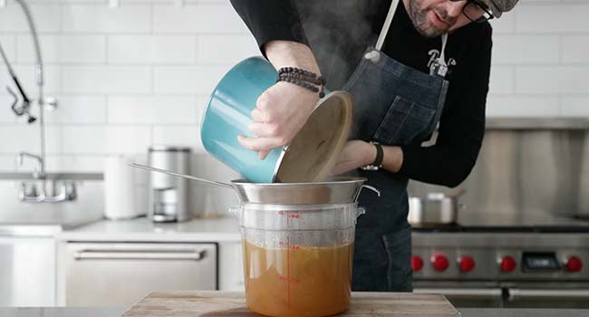 draining a chicken stock