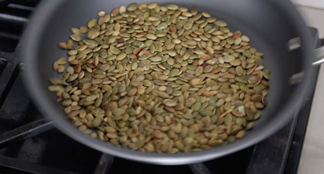 Toasting pepitas in a pan