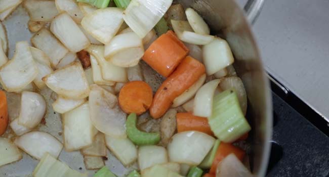 sautéing vegetables in a pan