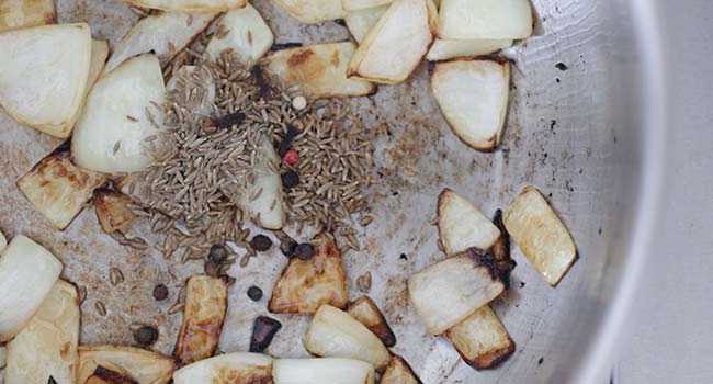 spices with onions and garlic in a pan