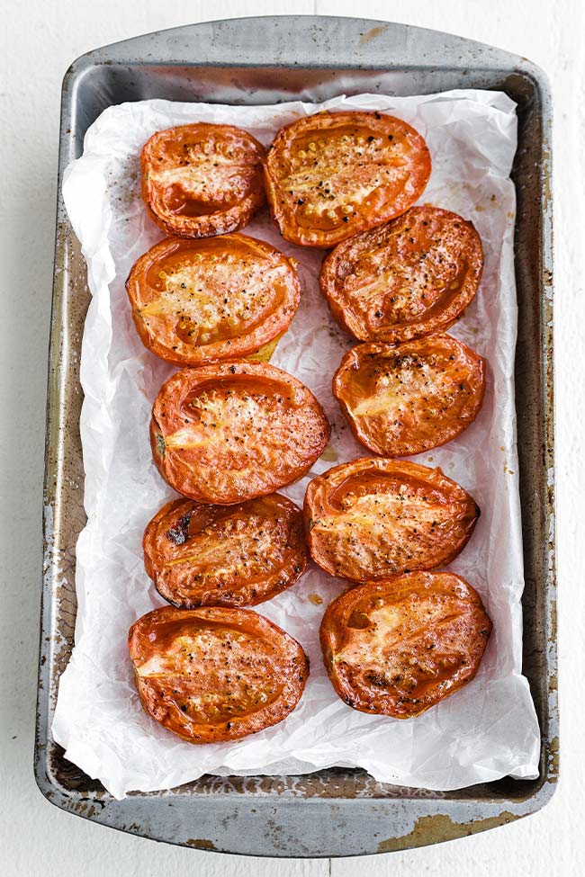 oven roasted tomatoes on a sheet tray