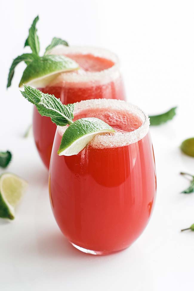 watermelon agua fresca in a glass with a sugar rim