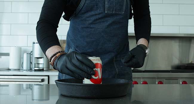 adding a beer can to a pan