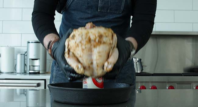 placing a whole chicken on a beer can
